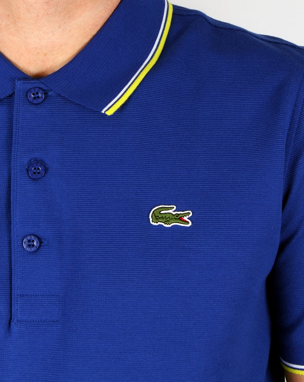 Lacoste – Poloshirt mit Streifen in Französischblau/Zitronengelb