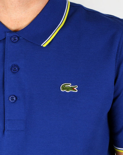 Lacoste – Poloshirt mit Streifen in Französischblau/Zitronengelb
