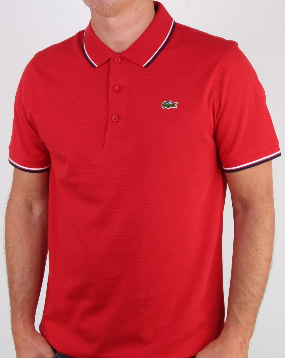 Lacoste – Poloshirt mit Streifen in Rot/Marineblau