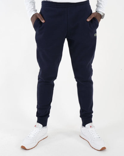 Lacoste – Schmale Fleece-Trainingshose mit Bündchen in Marineblau