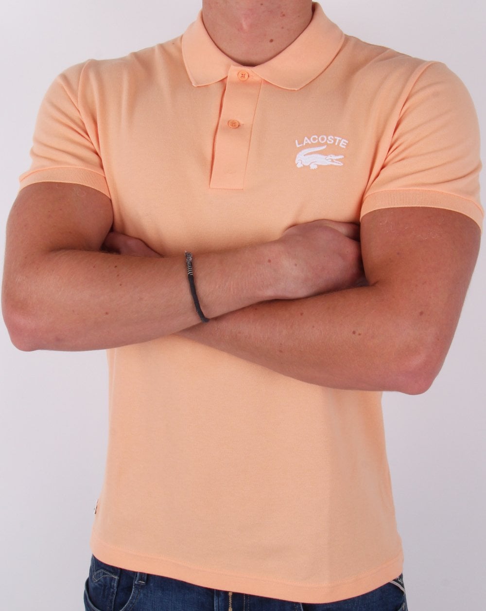 Lacoste – Poloshirt mit gesticktem Logo in Pfirsich