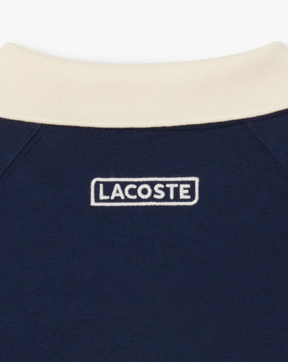 Lacoste – Poloshirt mit Piqué-Einsatz in Marineblau